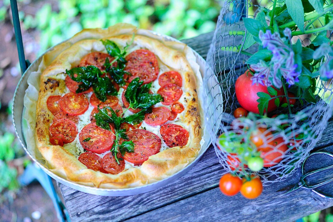 A tomato tart with fried basil leaves