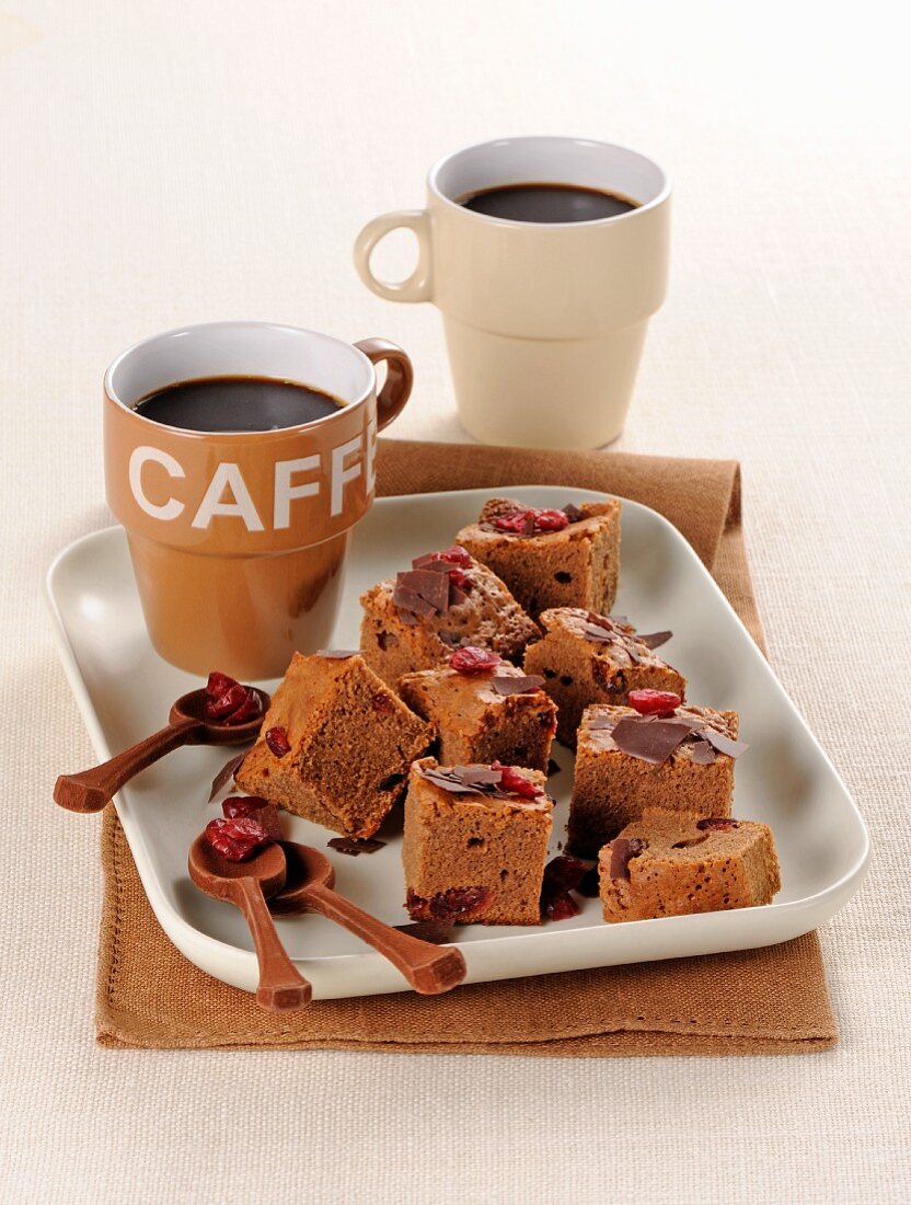 Chocolate brownies with dried cranberries served with coffee