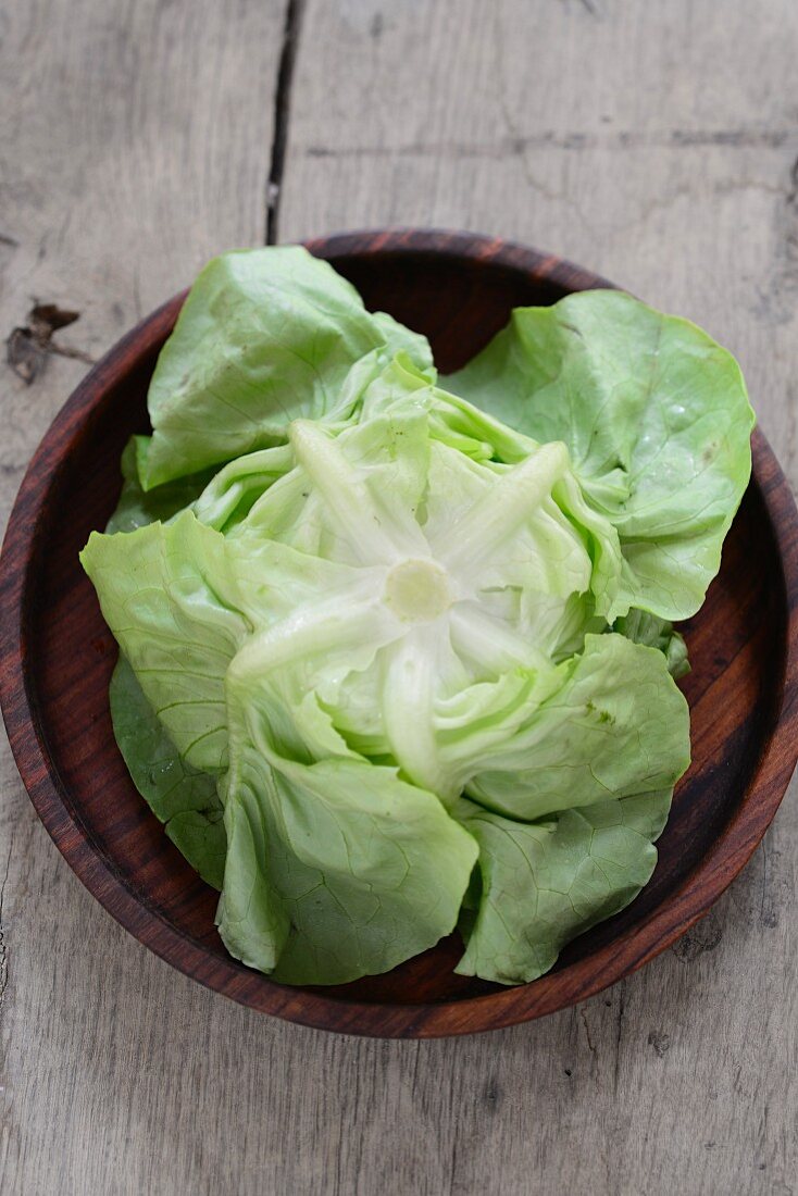 Fresh lettuce on a wooden plate
