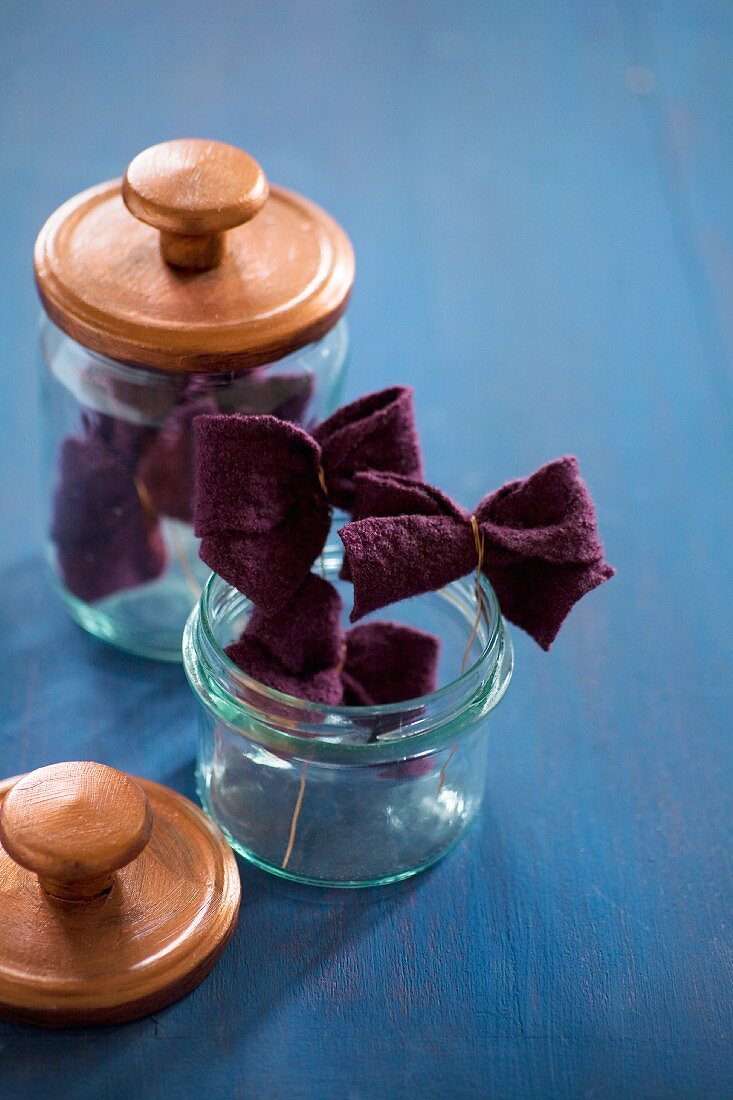 Felt bows in storage jars with lids