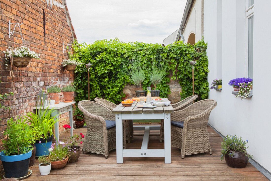 Rustic seating area on terrace with brick wall
