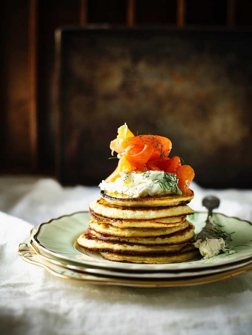 A stack of potato pancakes with herb crème fraiche and smoked salmon