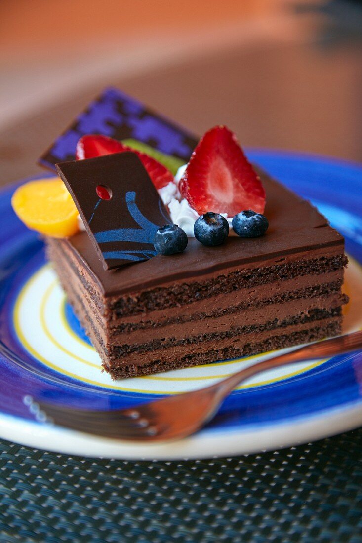A layered chocolate cake with fresh berries