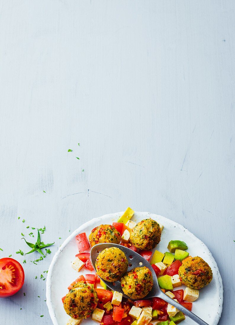 Millet falafel with a tomato and avocado salad