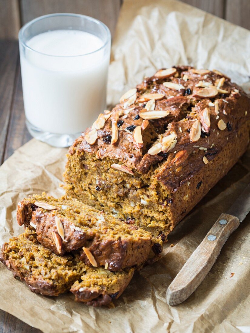 Vegan gingerbread and pumpkin cake with almonds and cranberries