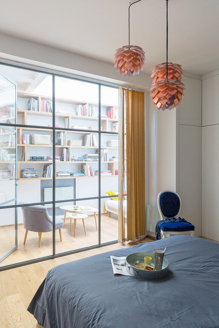 View from bedroom into living room through glass wall