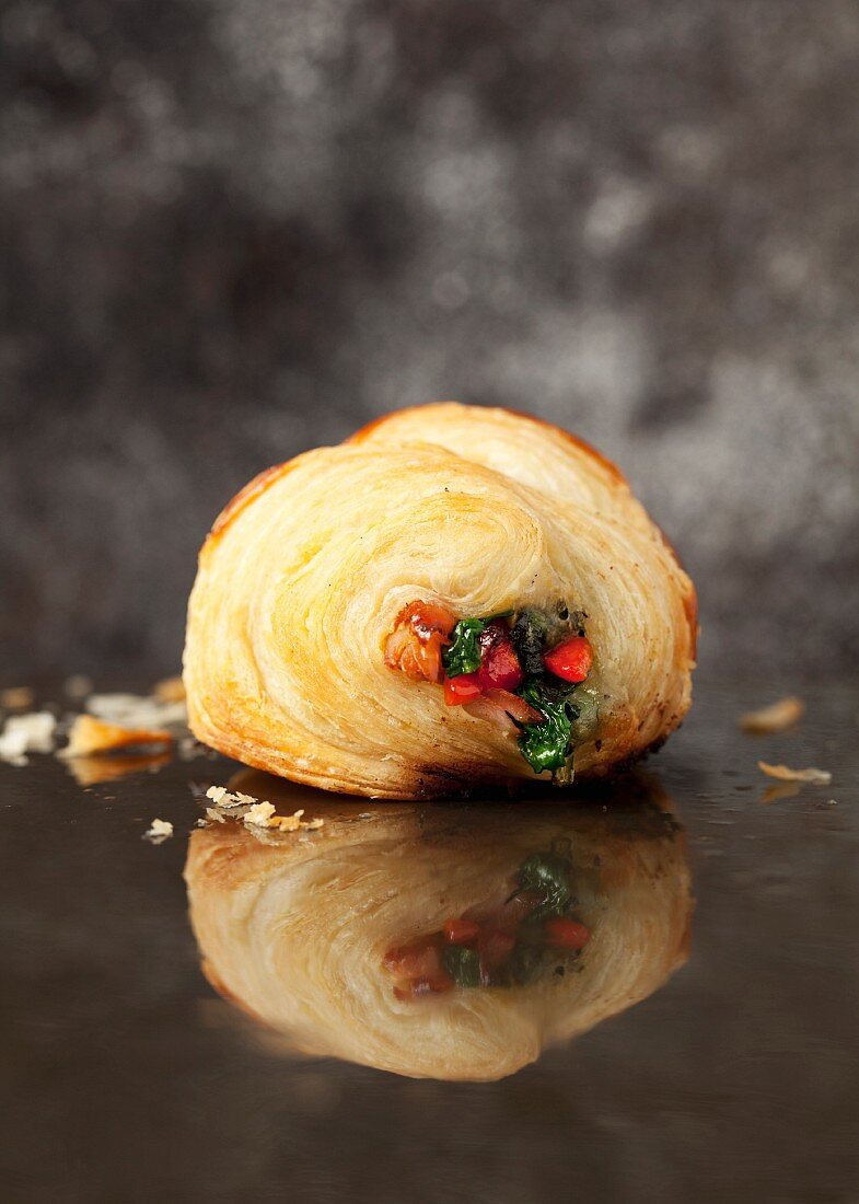 A pastry filled with spinach, pepper and ham
