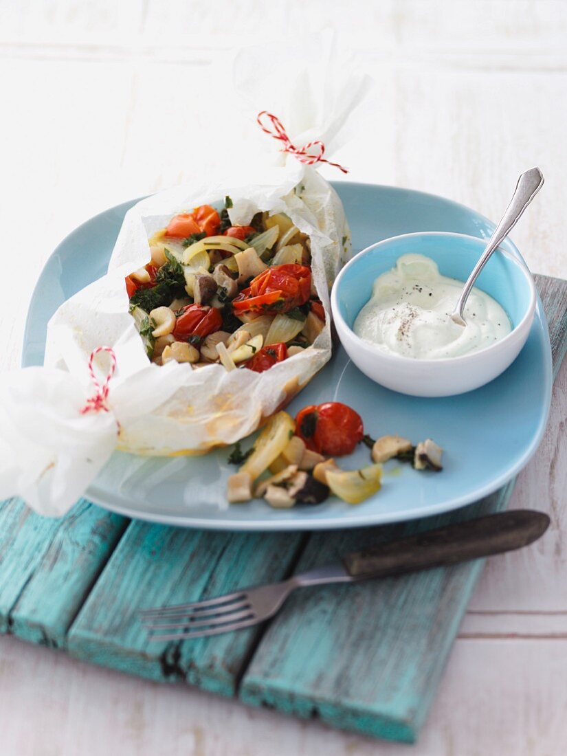 Mushroom and tomato medley in parchment paper with a tofu dip