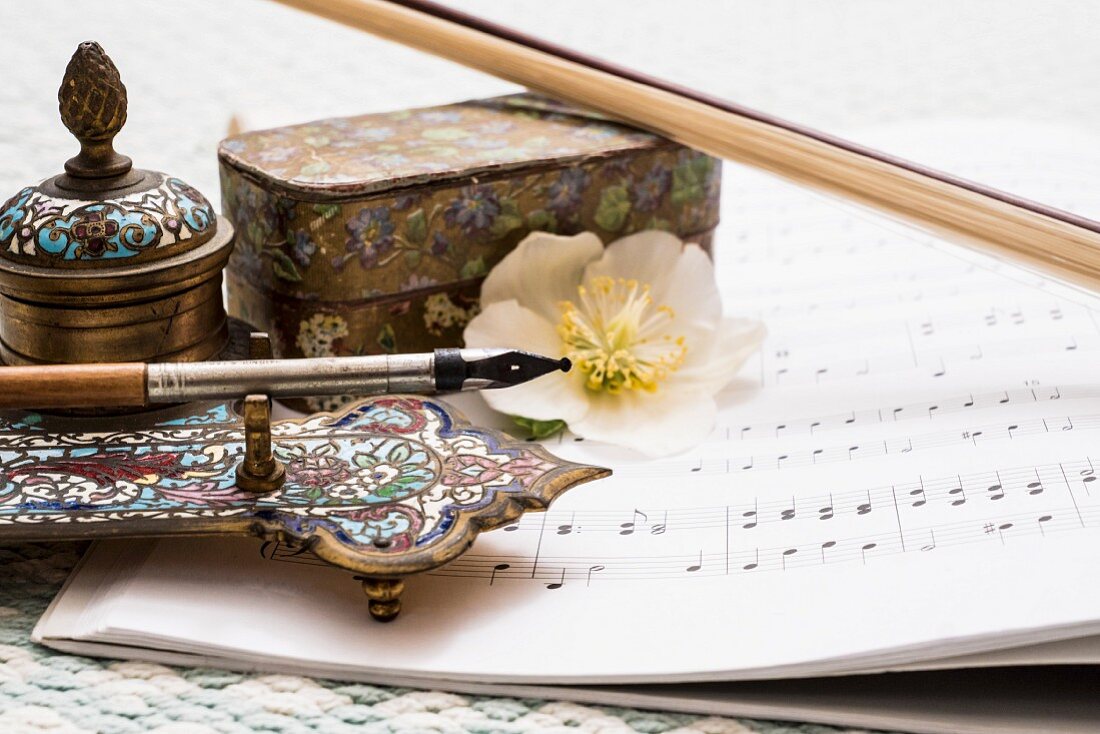 Vintage, artisanal writing utensils, sheet music and hellebore flower