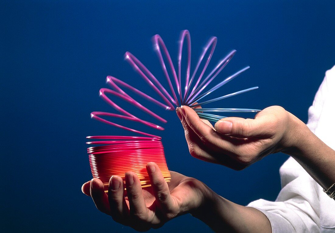 Slinky spring toy being held in hands