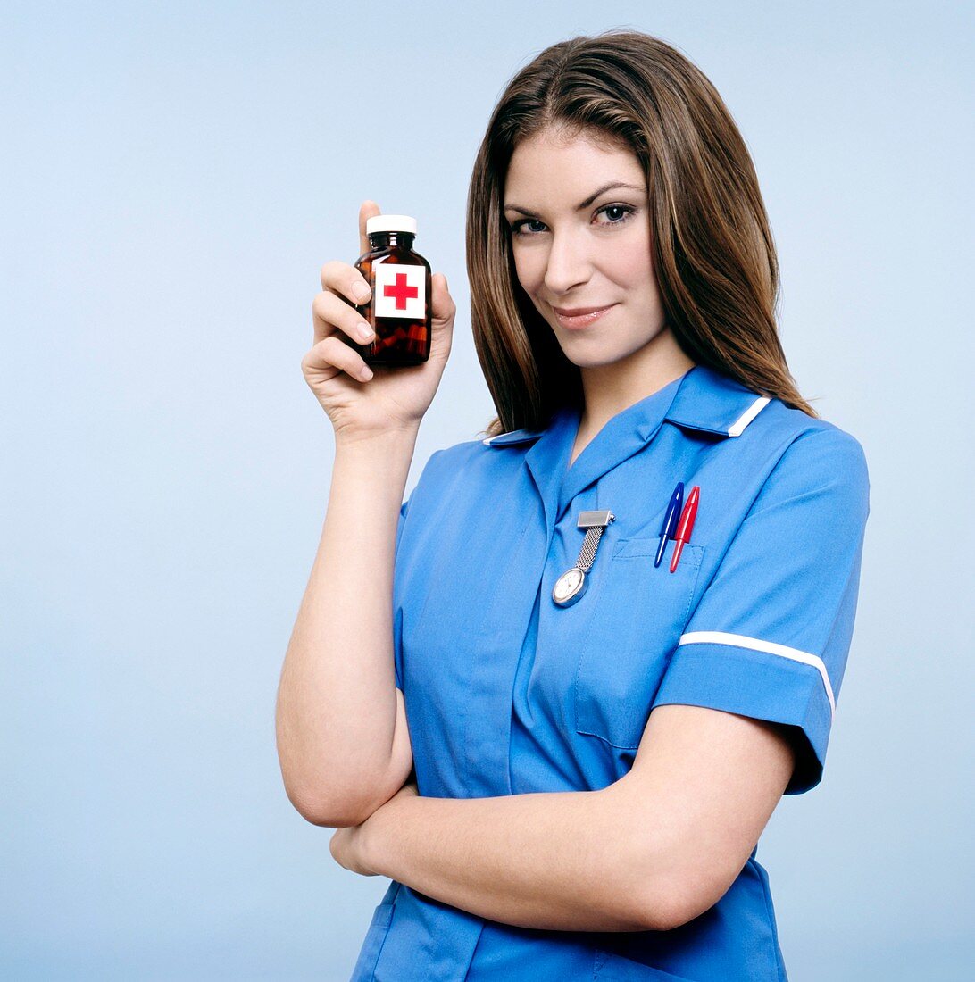 Nurse holding a bottle of pills