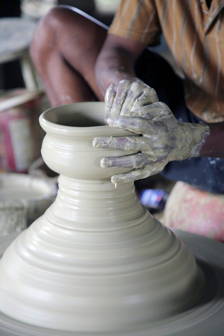 Potter making pot of clay
