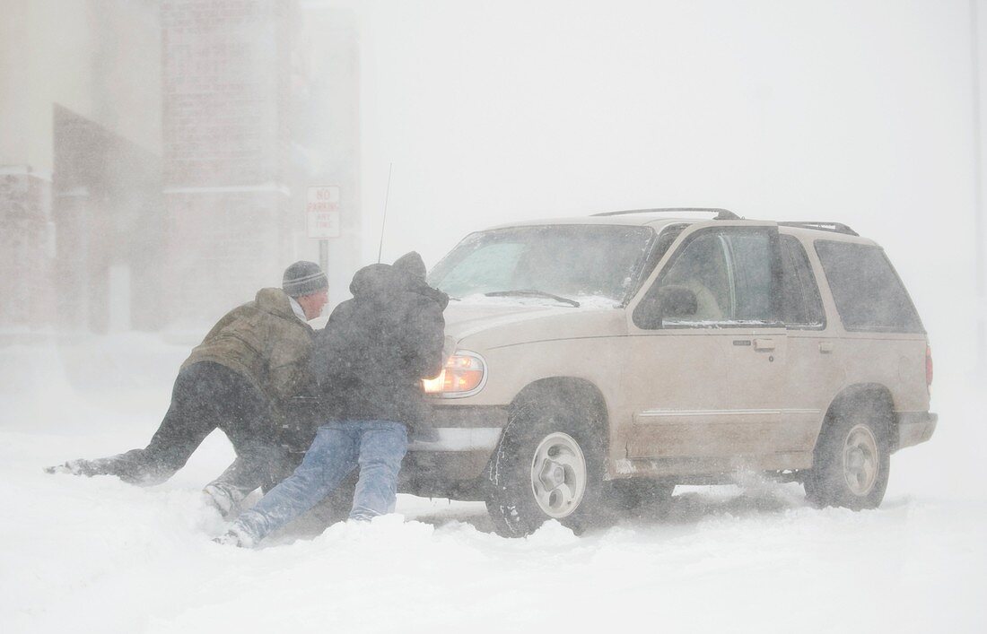 Pushing a car in a blizzard