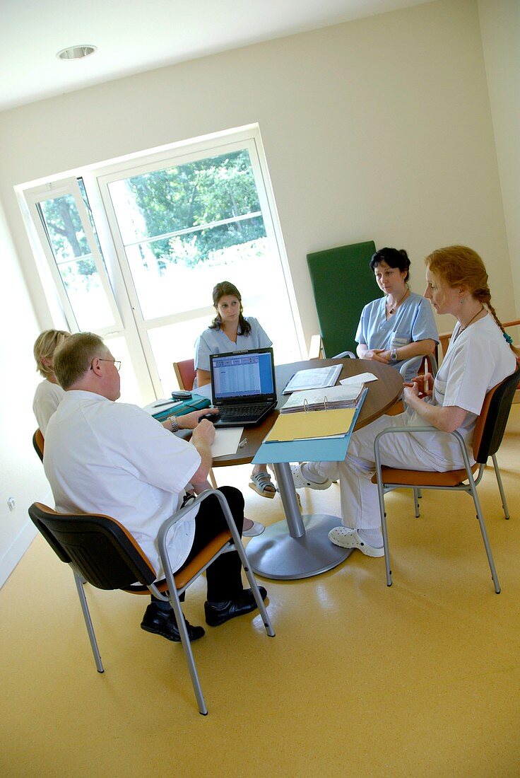 Healthcare workers conduct a meeting