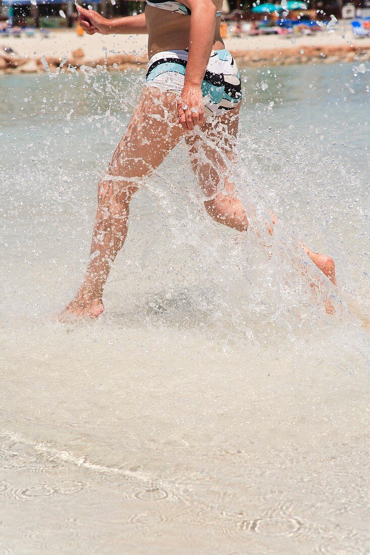 Woman splashing in sea water