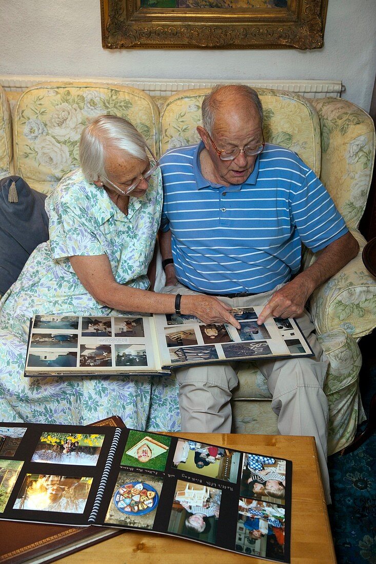 Elderly couple looking at family photos