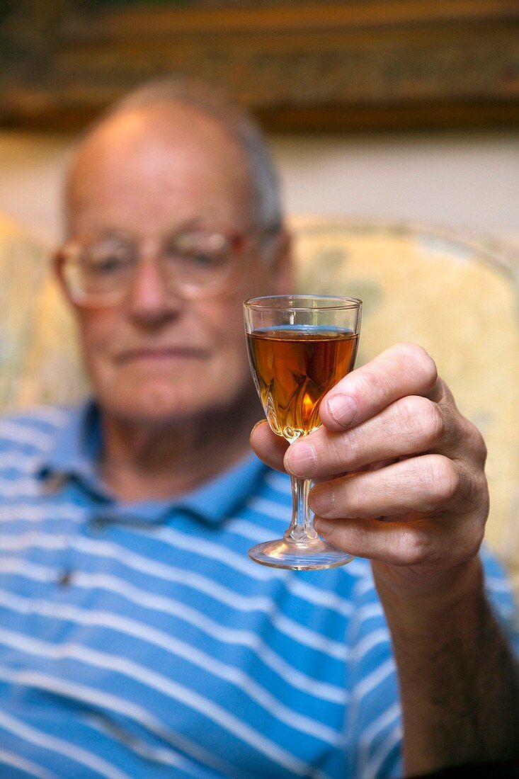 Elderly man with a glass of sherry