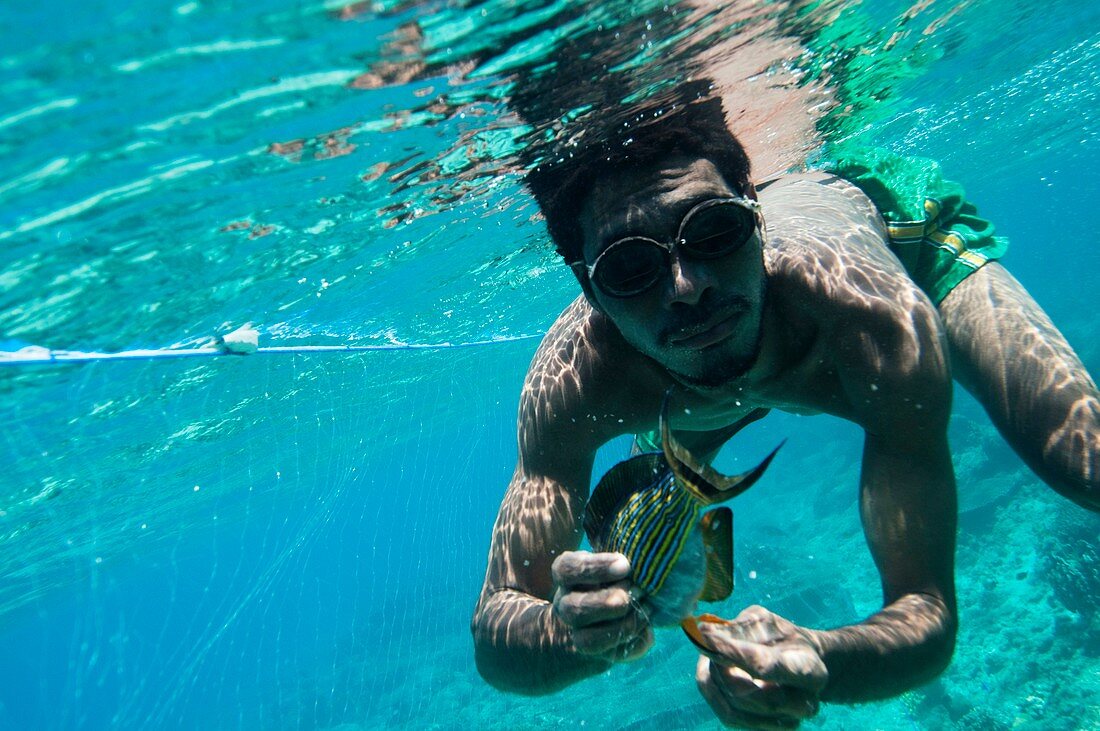Fisherman diving underwater