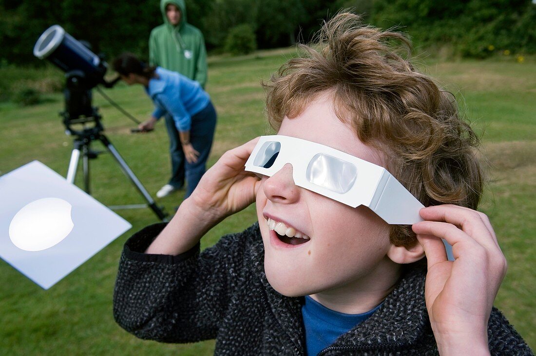 Boy observing solar eclipse