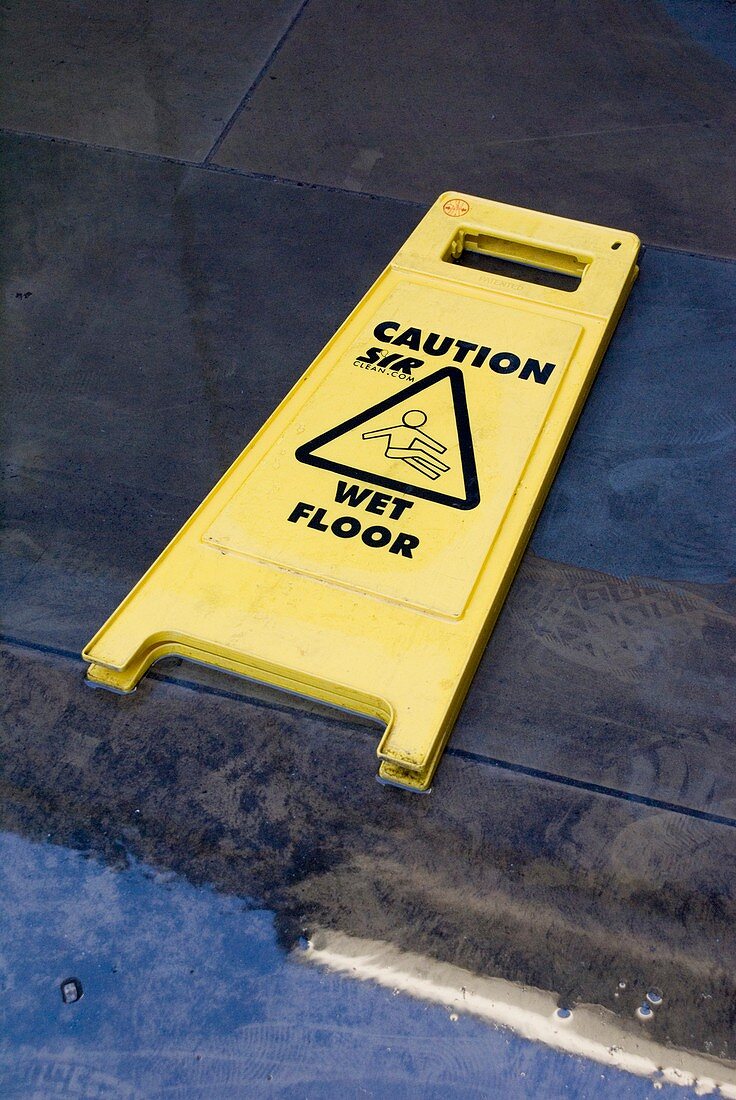 Wet floor sign in puddle