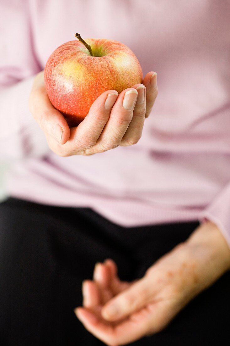 Holding an apple