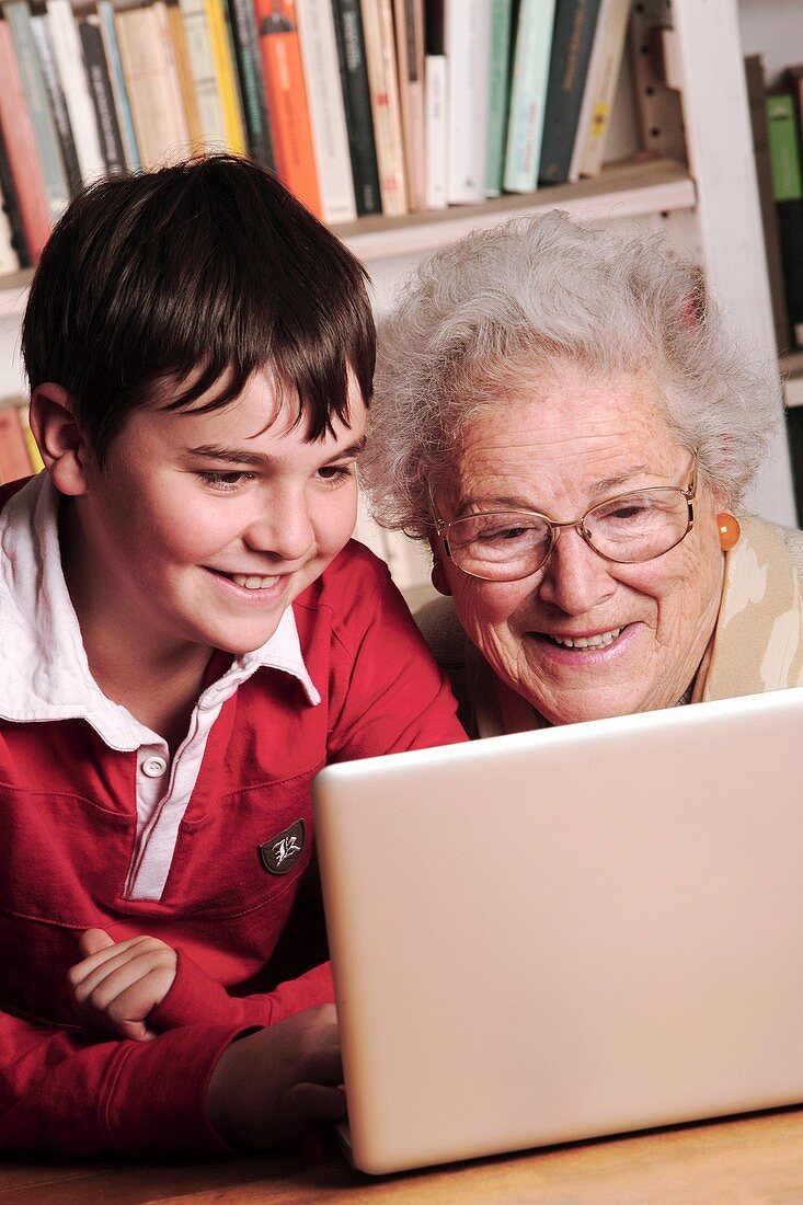 Elderly lady learning to use a laptop