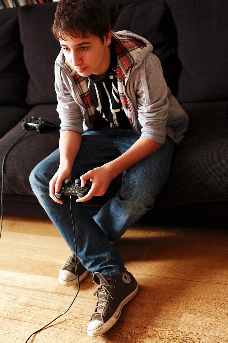 Teenager playing a video game