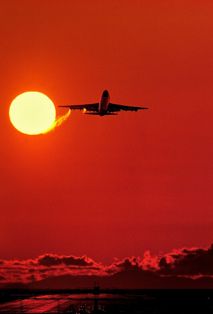 Boeing 747 taking off at sunset