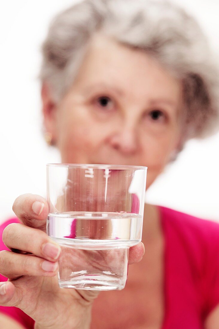 Elderly woman with a glass of water