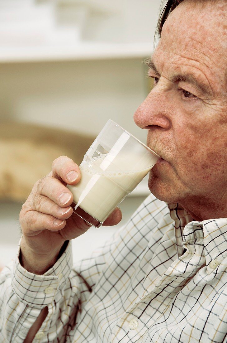 Elderly man drinking milk