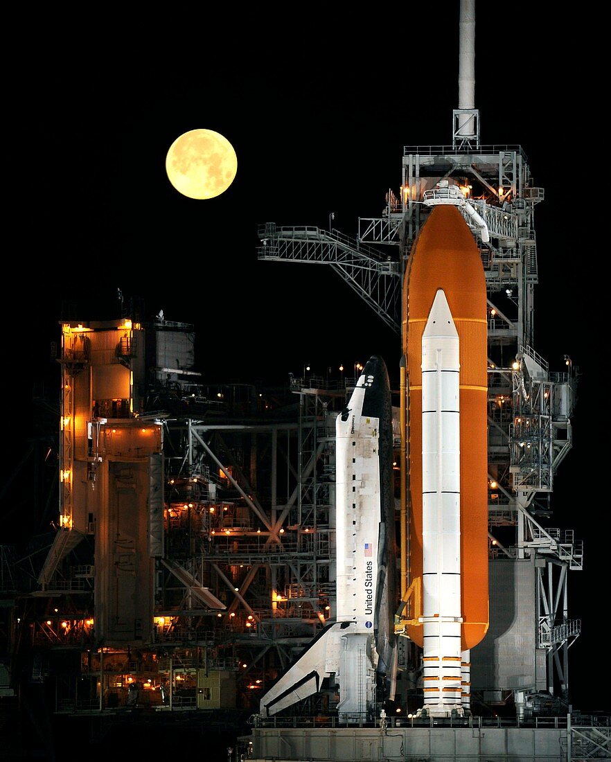 Space shuttle on launchpad at night