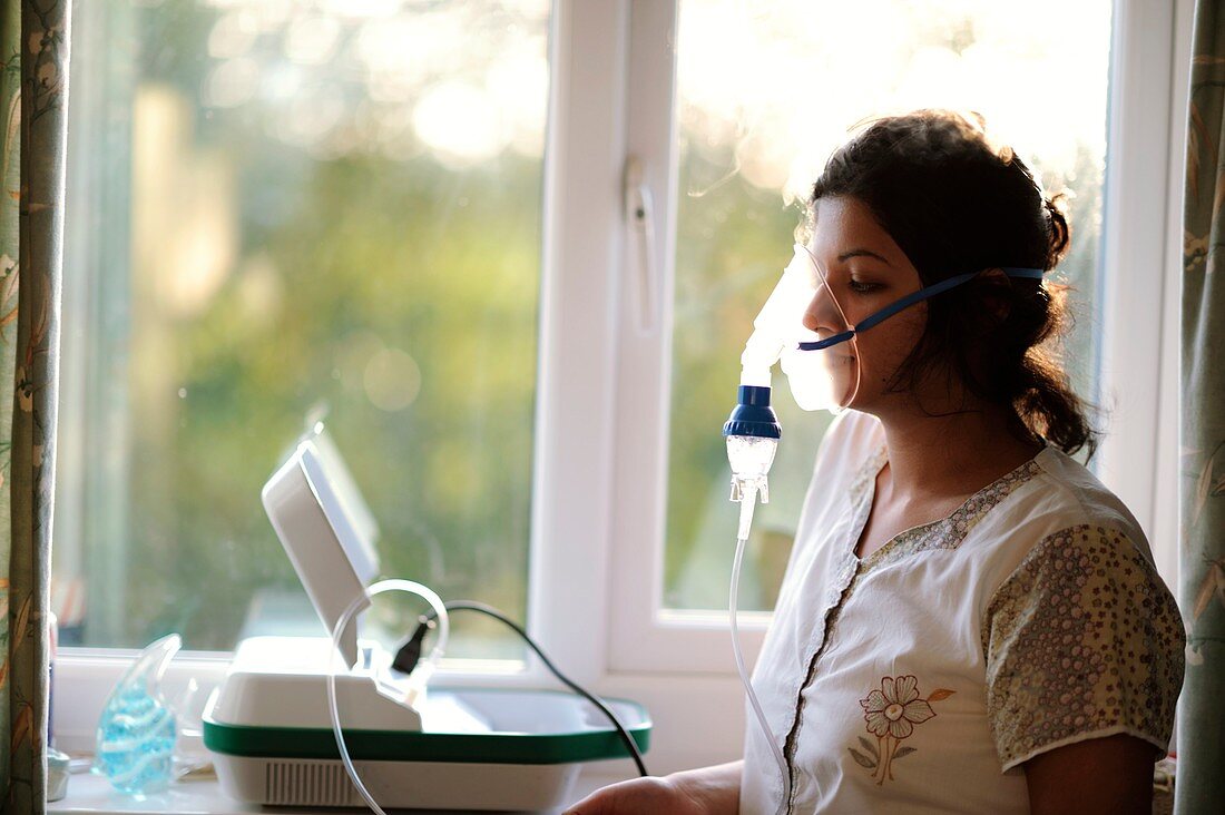 Woman using a salbutamol nebulizer