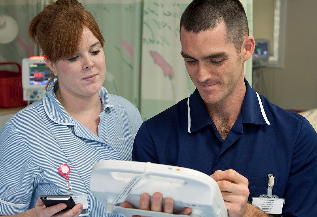 Nurses using handheld computers
