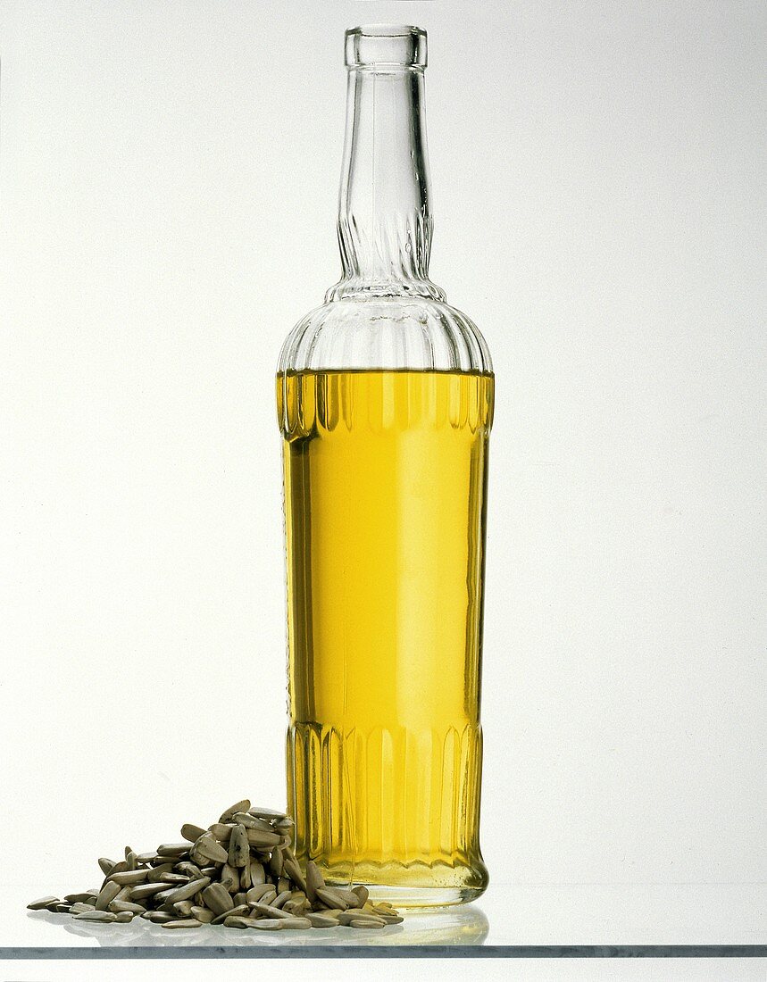A Bottle of Sunflower Oil with Sunflower Seeds