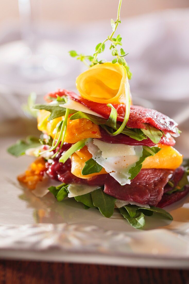 Beef carpaccio with rocket, yellow peppers and Parmesan