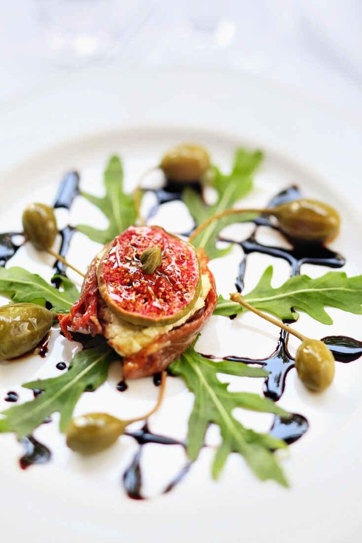 Goat's cheese with figs, dried tomatoes, capers, rocket and balsamic dressing