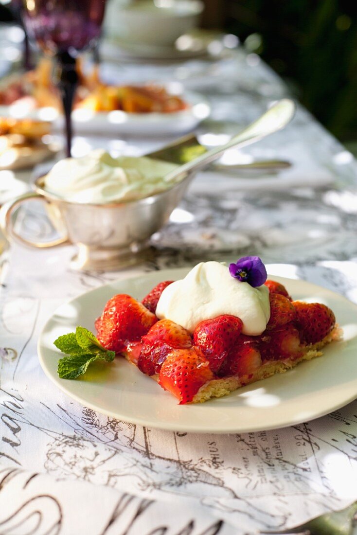 A slice of strawberry cake with vanilla cream