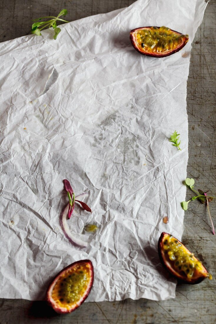 Parchment paper with a sliced passion fruit