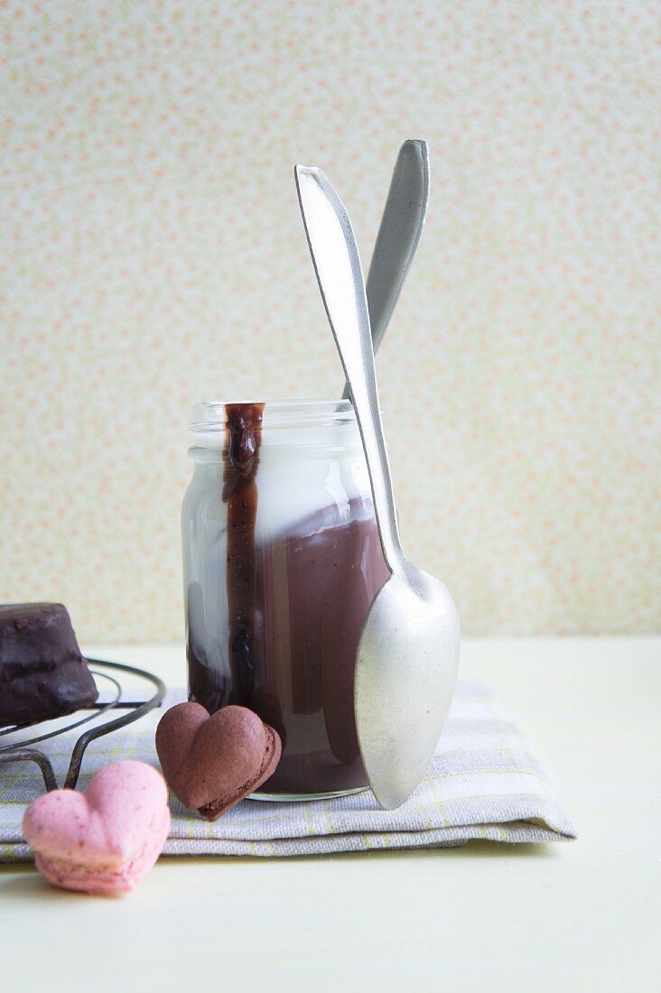 A jar of chocolate pudding with cream