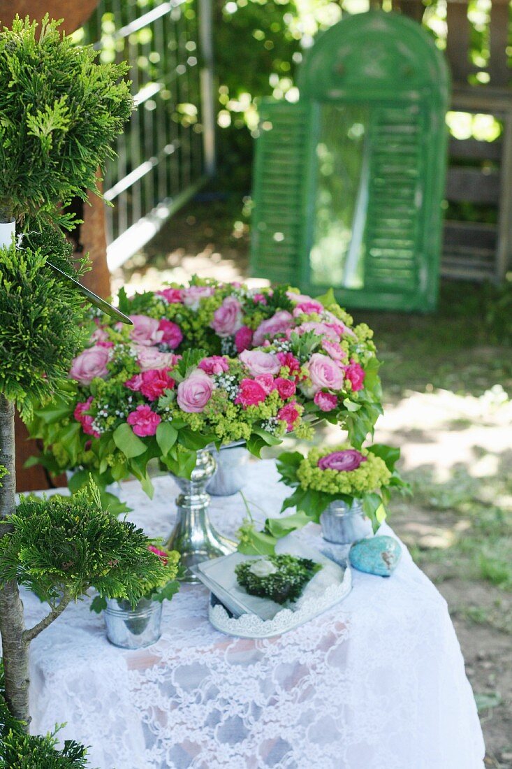 Wreath of roses in shades of pink at garden centre