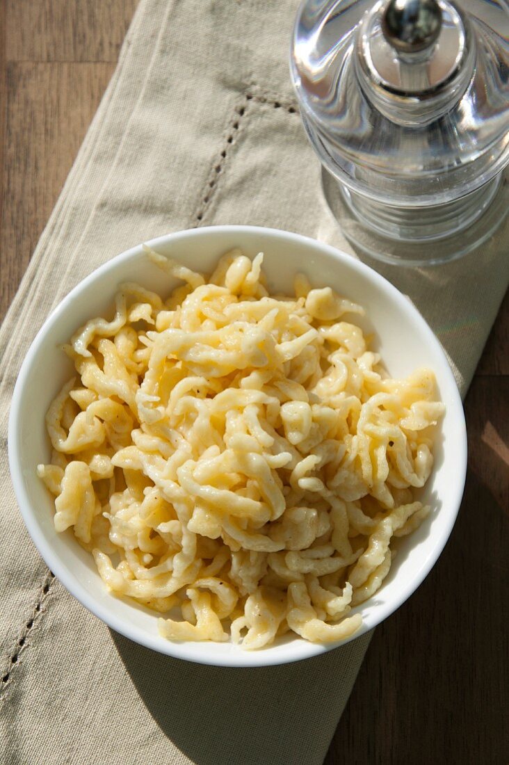 Butter Spätzle (soft egg noodles from Swabia) in a white porcelain bowl