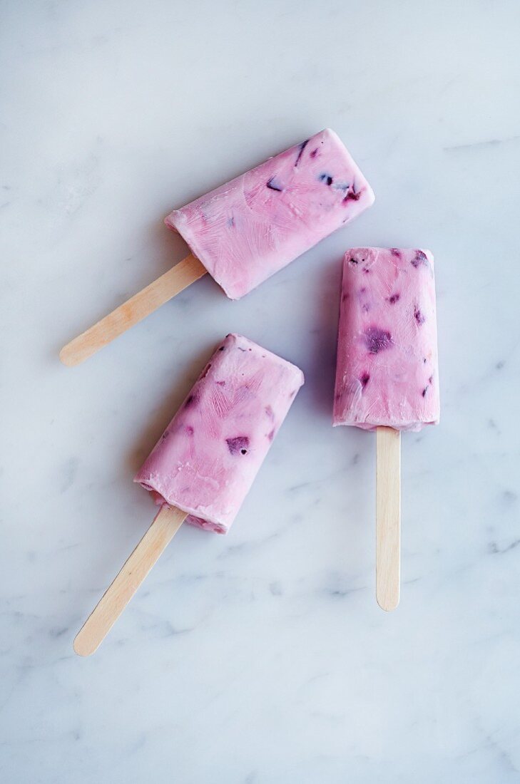 Three cherry yogurt ice cream sticks