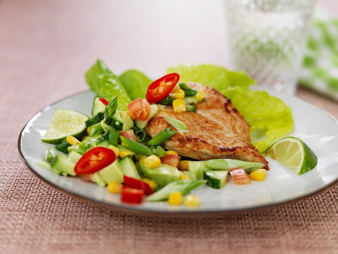 Fried chicken breast on a bed of spicy vegetables