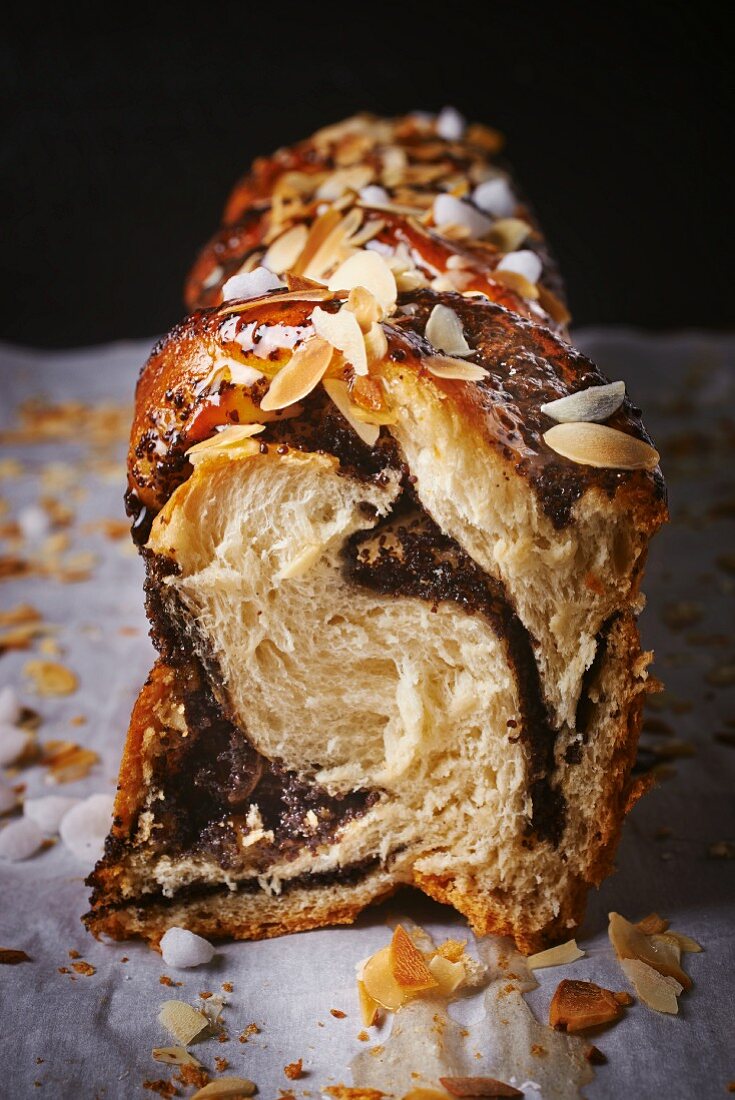 Braided yeast bread with poppy seeds and slivered almonds