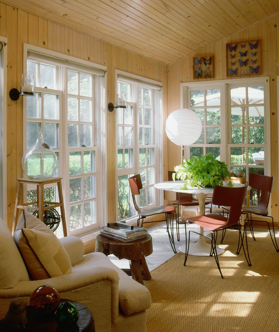 Dining area with designer chairs, classic table and lattice French windows