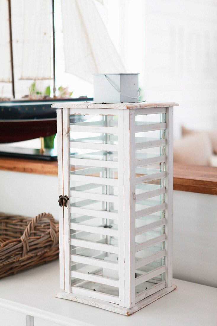 Lighthouse lantern made from white-painted wooden slats