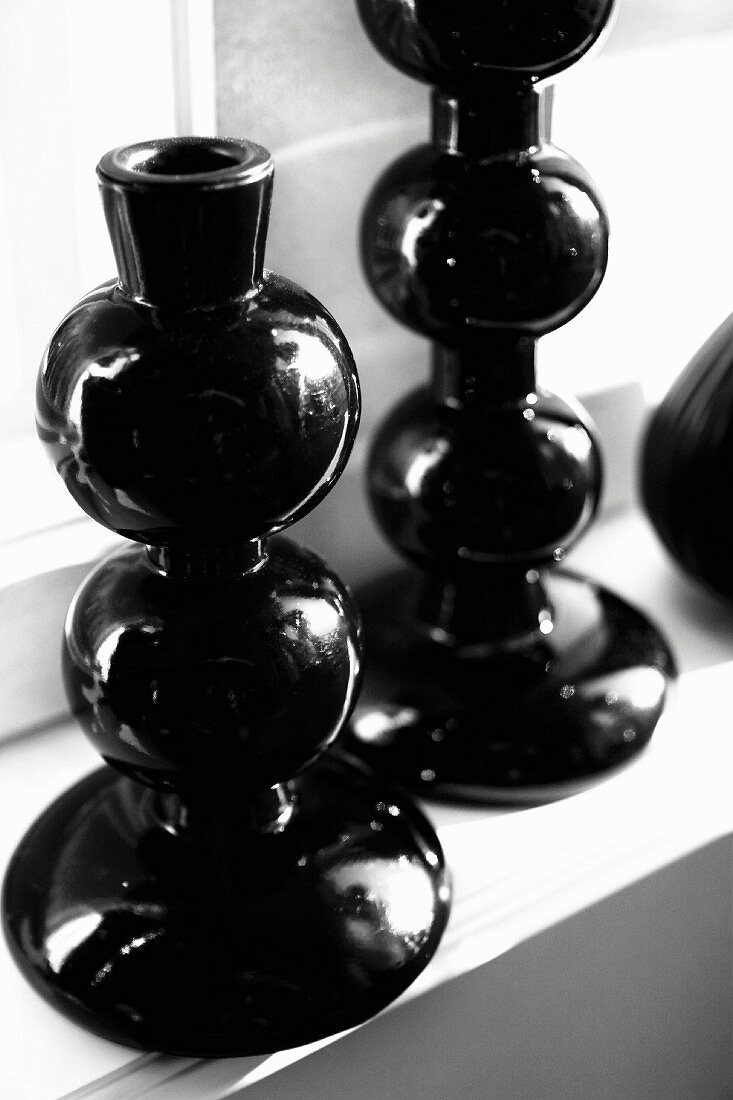 Black candlesticks on windowsill