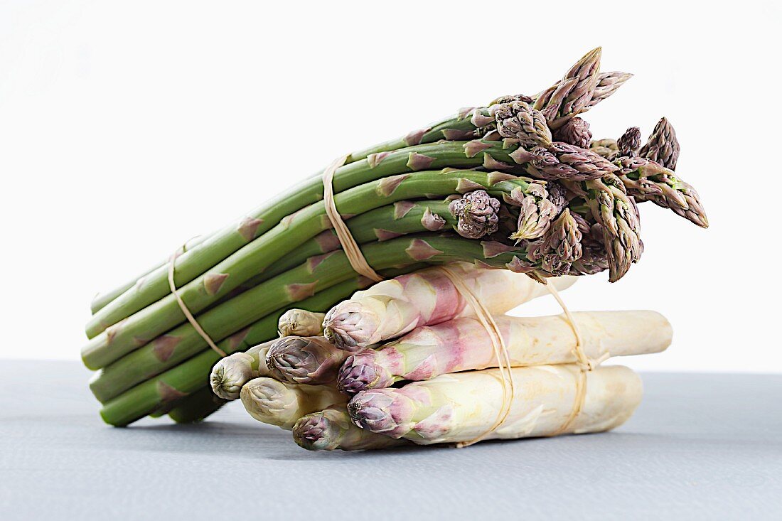 Bunches of asparagus, one lying on the other
