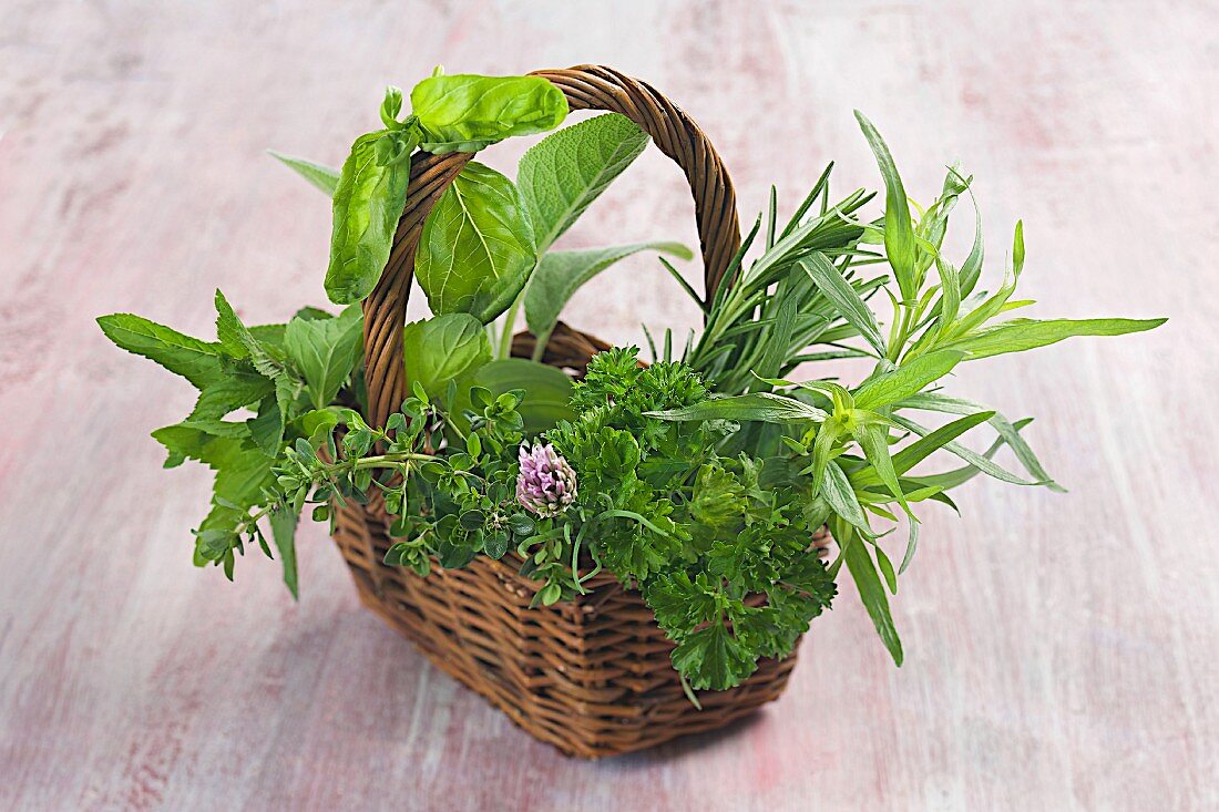 A wicker basket filled with fresh herbs