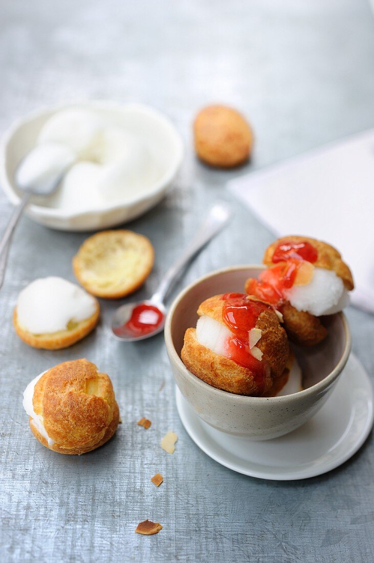 Profiteroles with peach ice cream and cherry sauce